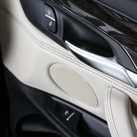 Interior of leather passenger compartment of the car in light tones.