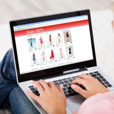 High Angle View Of A Young Woman Shopping Online On Laptop At Home